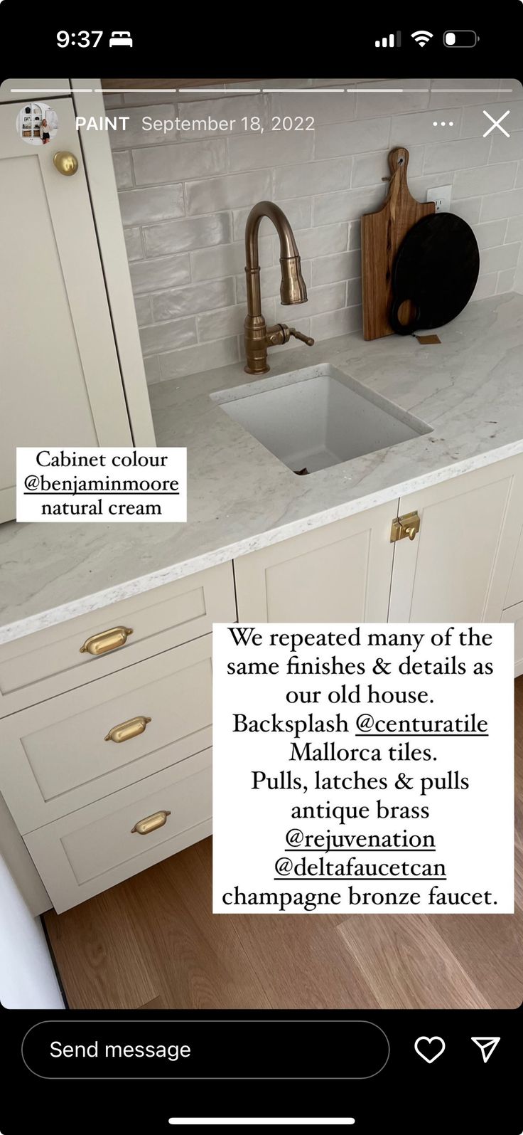 an image of a kitchen with white cabinets and marble counter tops on the phone screen