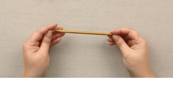 two hands are holding a piece of wood in front of a white background with the words,