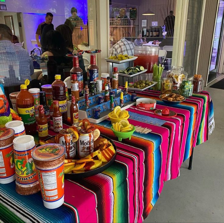 a colorful table covered in condiments and food