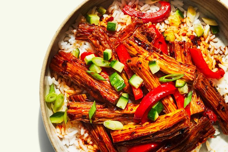 a bowl filled with rice, meat and veggies