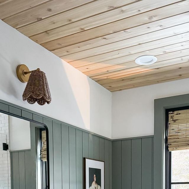 a bathroom with two sinks, mirrors and a painting on the wall above the sink