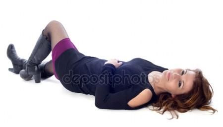 a woman laying on the ground with her legs spread out and wearing black boots,