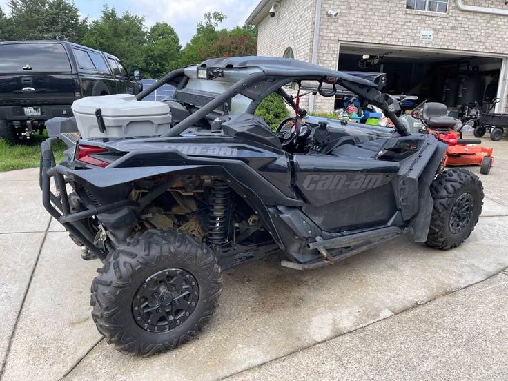 a black four - wheeled vehicle parked in front of a house