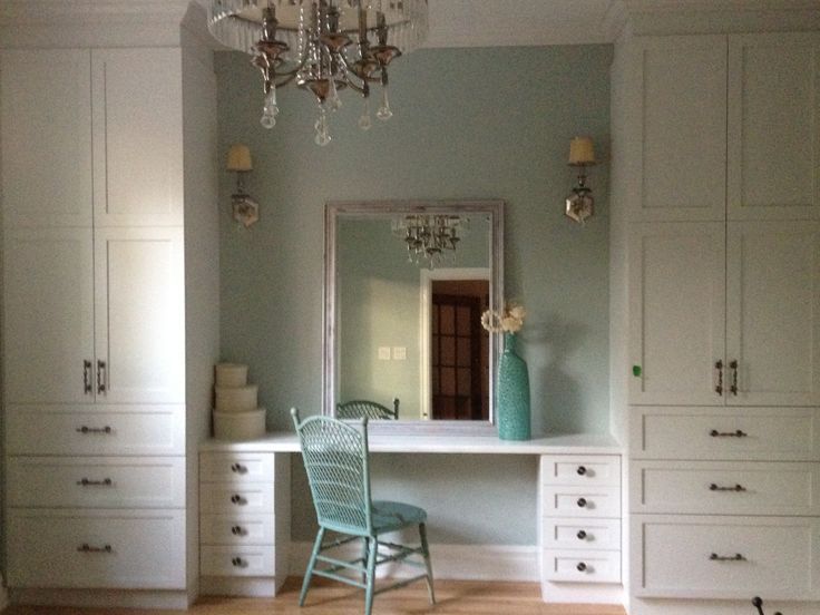 a room with white furniture and a chandelier