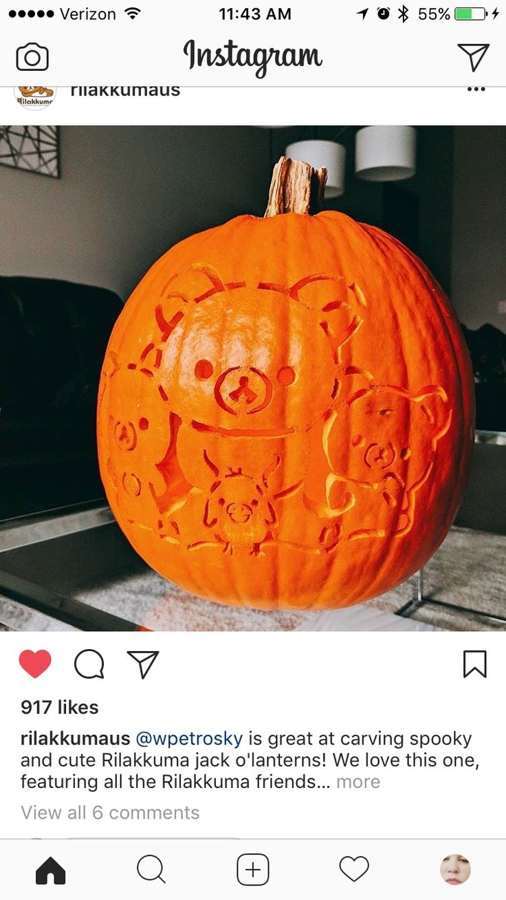 a pumpkin carved to look like an animal with faces on it, sitting on a counter