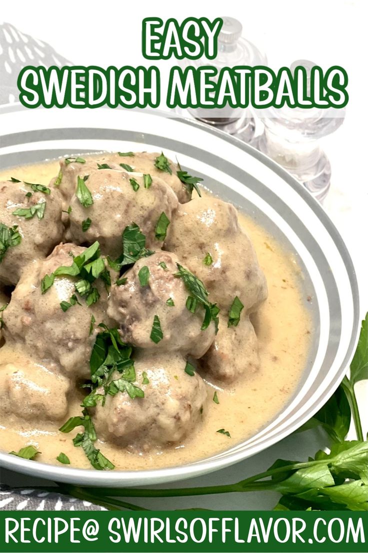 a white bowl filled with meatballs covered in gravy and garnished with parsley