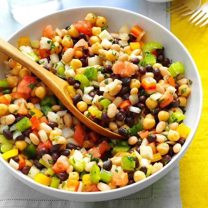 a white bowl filled with black beans and veggies on top of a table