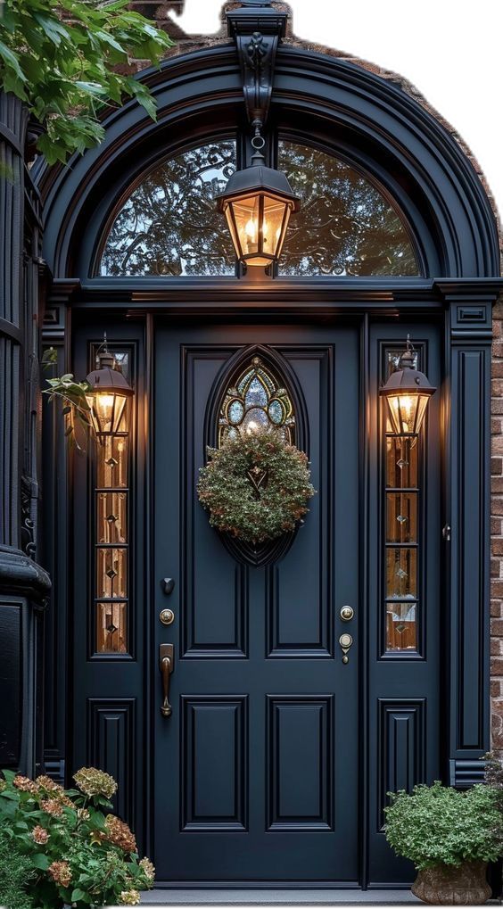 a blue front door with a wreath on the top and two lights at the bottom