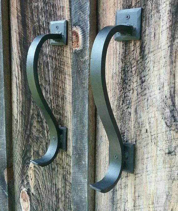 two metal hooks are attached to wooden boards