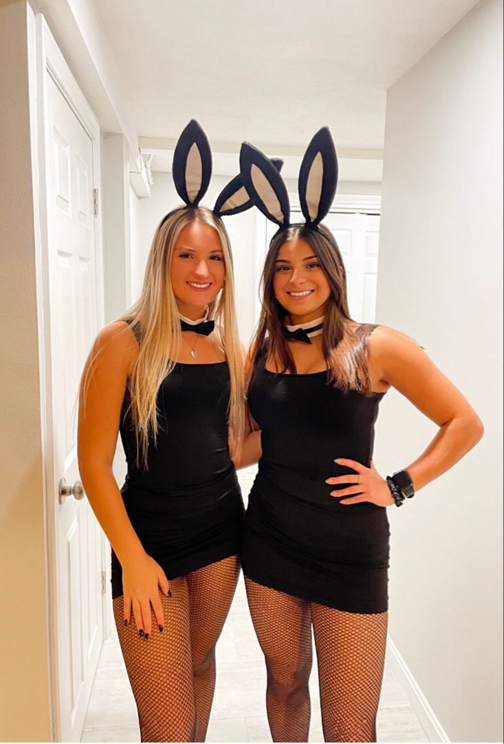 two women in bunny ears are posing for the camera