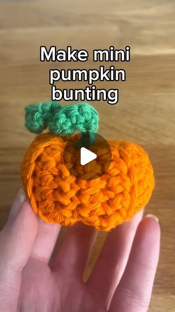 an orange crocheted pumpkin with green leaves on it's head and the words make mini pumpkin bunting