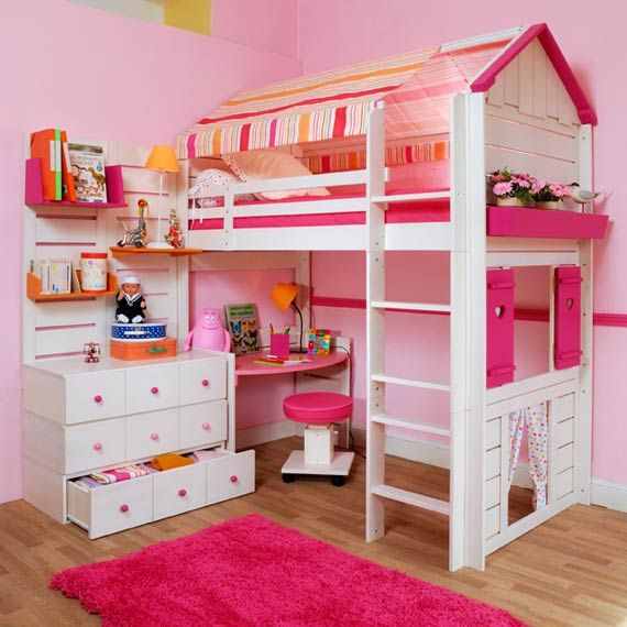 a child's bedroom with pink walls, white bunk beds and wooden flooring