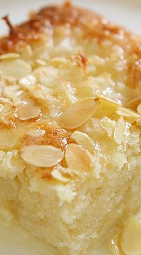 a close up of a piece of cake on a plate with almonds around it