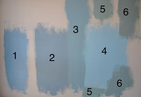 blue and white paint is being painted on the wall with numbers in front of it