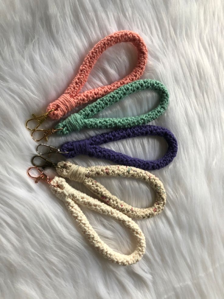 four crocheted lanyards on white fur