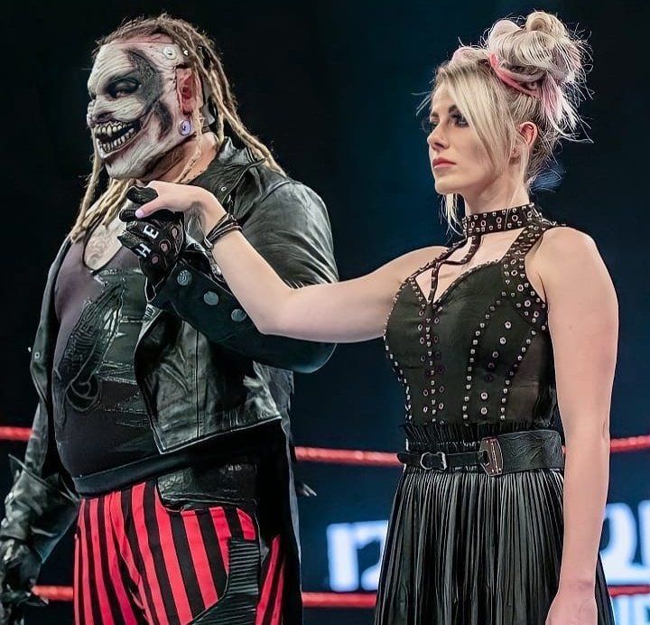 two women with makeup on their faces standing next to each other in front of a ring