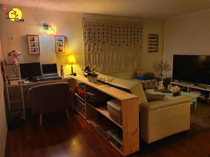 a living room filled with furniture and a flat screen tv sitting on top of a hard wood floor