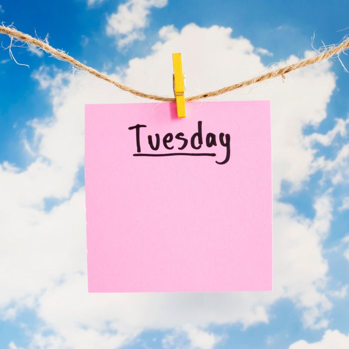 a pink sticky note pinned to a rope with the word tuesday written in black on it