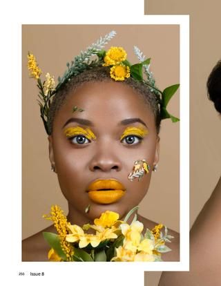 a woman with yellow makeup and flowers in her hair is posing for the camera,