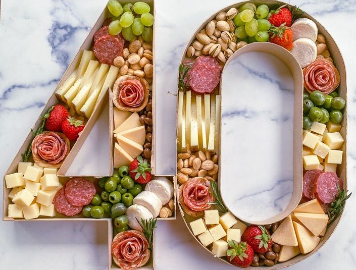 the number forty is made up of cheese, crackers, grapes, and nuts