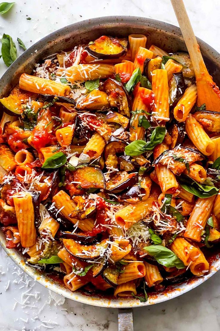 a skillet filled with pasta and vegetables