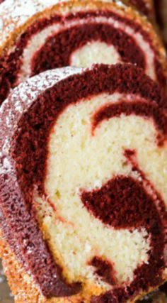 sliced red velvet swirl cake with powdered sugar on top