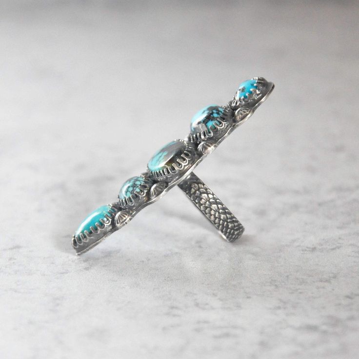 A statement ring of mixed turquoise. Sterling silver is patinaed for a weathered + antiqued look. Set in an hand forged bezel and a hand forged beaded band. D E T A I L S • Sterling Silver • 1.875"h x .75"w x .125"d • Size 7.25 US The ring will be carefully wrapped in tissue and placed in a decorative kraft box. It's ready to give to that special person! Turquoise Hand Forged Artisan Rings, Unique Hand Forged Turquoise Ring, Bohemian Hand Forged Turquoise Ring, Adjustable Hand-tooled Turquoise Jewelry, Adjustable Silver Turquoise Multi-stone Ring, Adjustable Multi-stone Turquoise Ring In Silver, Unique Nickel-free Sterling Silver Turquoise Ring, Adjustable Southwestern Turquoise Ring Nickel-free, Kraft Boxes