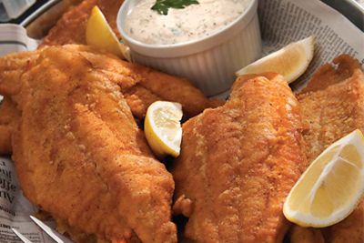 fried fish with lemon wedges and dipping sauce