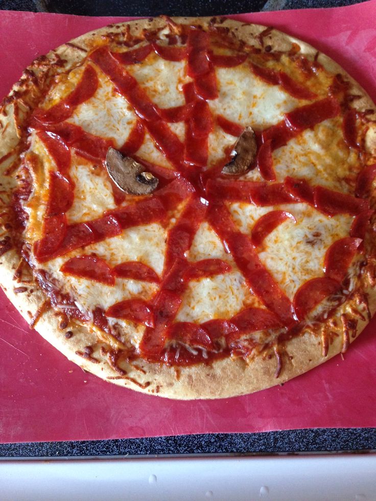 a pizza sitting on top of a pink tray covered in cheese and ketchup