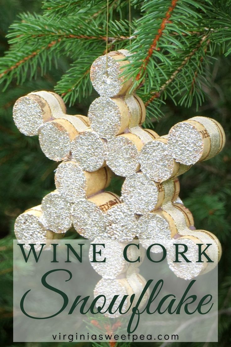 wine cork snowflake ornament hanging from a christmas tree with the words wine cork snowflake on it