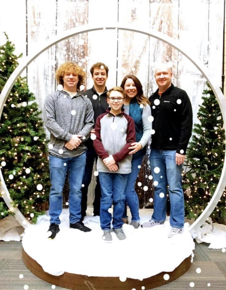 a group of people standing in front of a snow globe