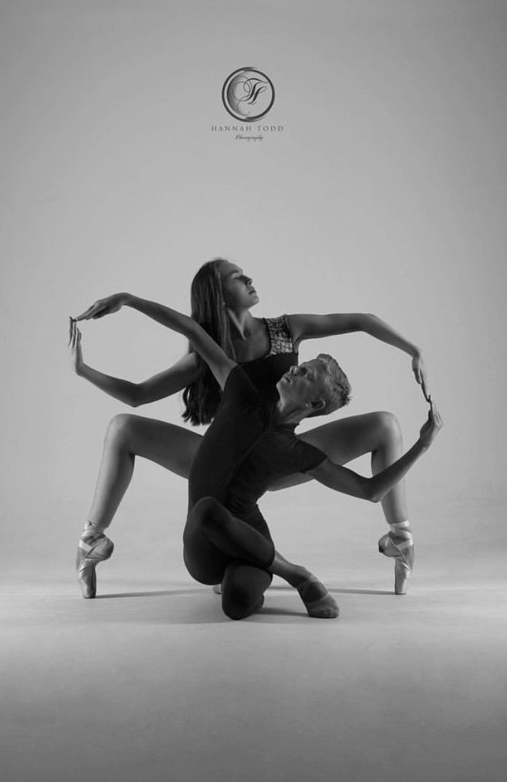 two women in black and white pose for the camera with their hands on each other's hips