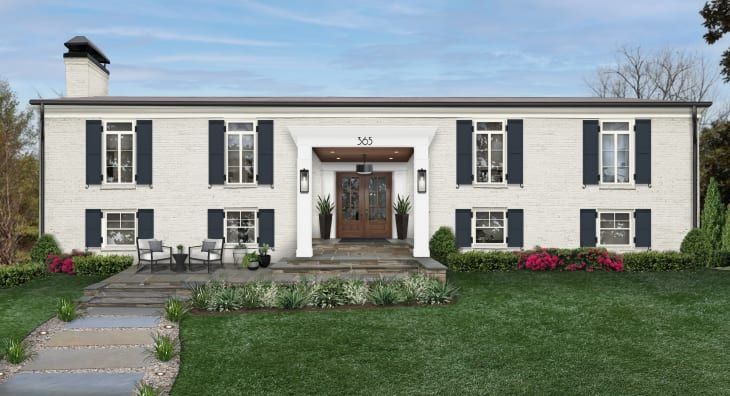 a large white house with black shutters on the front door and windows in the side