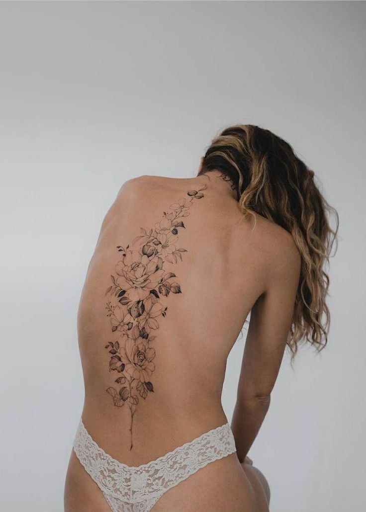 the back of a woman's body with flowers on it