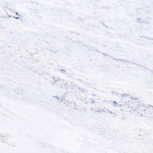 a man riding skis down the side of a snow covered slope on a snowy day