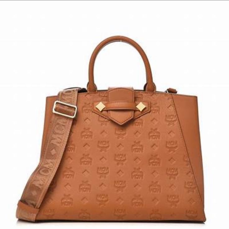 Beautiful New Mcm Cognac Monogrammed Tote Bag Can Be Paired With Any Outfit Work Or Casual. New With Tags Dimensions 10h X 12l X 5xw ( Actual Bag Size Not Including Handle) Monogram Canvas Tote Bag With Detachable Strap, Luxury Tan Tote Bag, Luxury Tan Satchel Bag, Chic Bags With Handle Drop In Monogram Canvas, Chic Bags With Handle Drop And Monogram Canvas, Luxury Monogram Canvas Formal Bag, High-end Monogram Canvas Bag For Formal Occasions, Brown Light Luxury Tote Bag, Evening Monogram Canvas Tote Bag