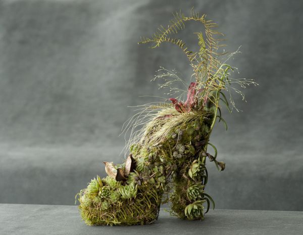 an animal made out of moss and plants