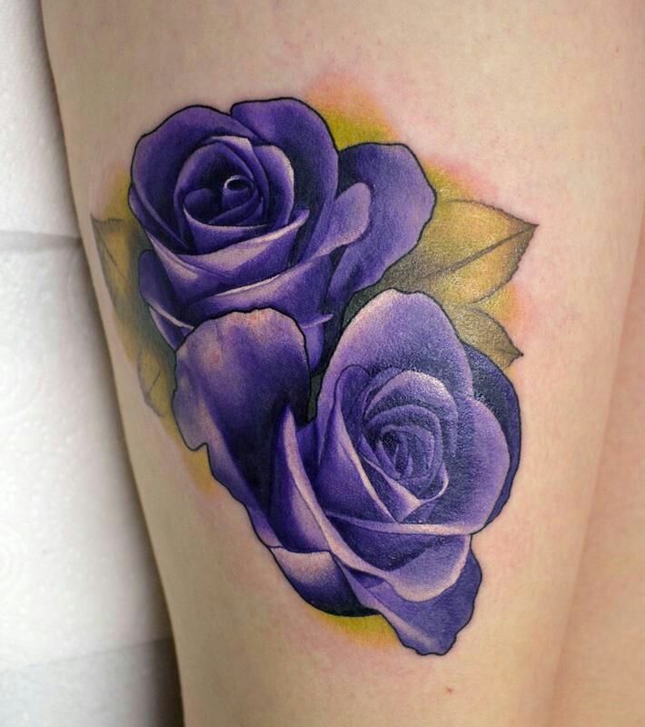 a tattoo with two purple roses on it