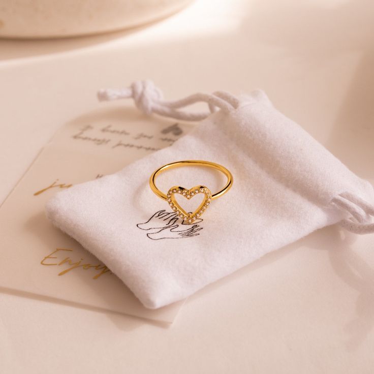 Inspired by the goddess of love and beauty, our Aphrodite Pave Heart Ring is designed with glimmering diamond stones joined together to form a heart, inviting those who wear this special ring to fall in love. Simply the perfect Anniversary gift as love grows, will become a timeless romantic keepsake ✨ Material: High Quality Solid 925 Sterling Silver Finish: 18K Gold Featuring 10mm Open Heart Ring with High Quality CZ Pave Diamonds SKU: RR-RR076 Sizing Guide Rings are created true to standard US Goddess Of Love And Beauty, Open Heart Ring, Diamond Heart Ring, Special Ring, Goddess Of Love, Anniversary Gift For Her, The Goddess, Love Ring, Aphrodite