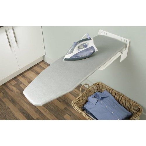 the ironing board is hanging on the wall next to an iron and clothes basket