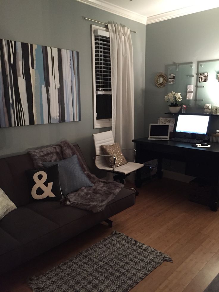 a living room filled with furniture and a laptop computer on top of a wooden floor