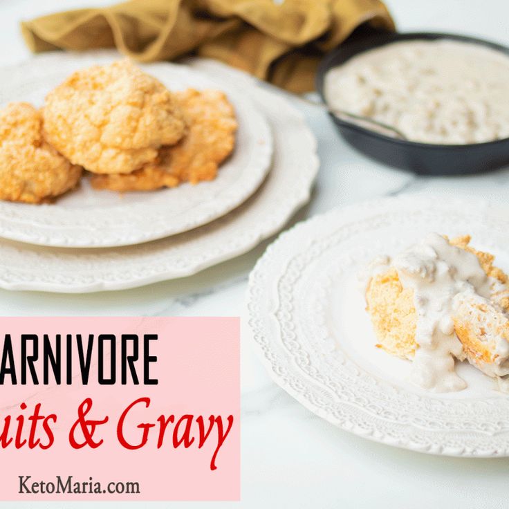 two white plates topped with biscuits and gravy next to each other on a table