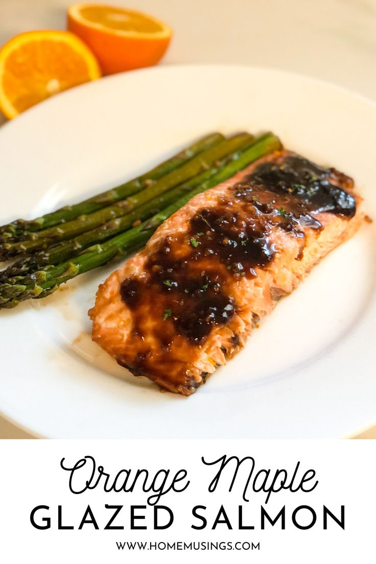 orange maple glazed salmon with asparagus on a white plate