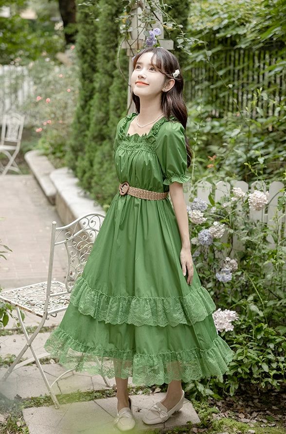 Leafy green midi dress with a ruffled square neckline, short puff sleeves and tiered midi skirt with lace trims. Matching belt included to snatch that waist. S: 36" chest, 27" waist, 43.5" lengthM: 37.5" chest, 28.5" waist, 43.5" lengthL: 39" chest, 30" waist, 44" lengthXL: 40.5" chest, 31.5" waist, 44" length Green Tiered Midi Dress With Ruffles, Green Tiered Ruffle Midi Dress, Green Tiered Midi Dress For Garden Party, Green Tiered Midi Dress With Ruffle Hem, Green Midi Dress With Ruffle Hem And Square Neck, Tiered Green Midi Dress With Ruffle Hem, Midi Dress Green, Tiered Midi Skirt, Skirt With Lace