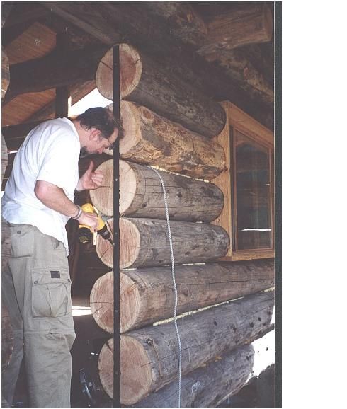 a man and woman are working on some logs