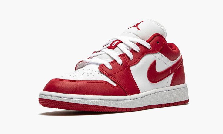 a pair of red and white sneakers on a white background