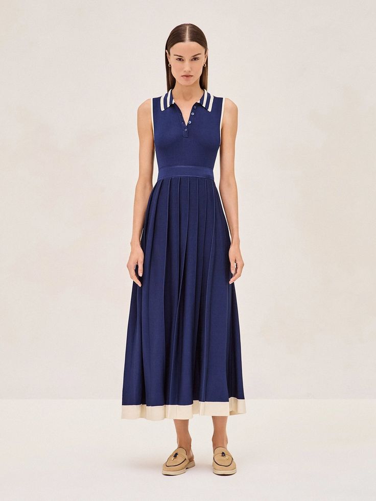 The Ciele Midi Dress is a perfect blend of elegance and comfort. Its collar and button detail give a subtle nod to classic style, while the marine blue flows into a pleated midi skirt trimmed with a broad, ivory hem that adds just the right amount of contrast. It's a versatile piece that works for both office settings and weekend brunches. Pair it with sandals for a relaxed yet sophisticated look. Classic Blue A-line Midi Dress, Classic Summer Pleated Dress, Elegant Blue Dress With Box Pleat, Classic Summer Midi Length Pleated Dress, Classic Pleated Dress With Pleated Hem For Summer, Classic Midi Length Pleated Summer Dress, Classic Midi-length Pleated Dress, Navy Pleated Summer Dress, Blue Pleated Midi Dress