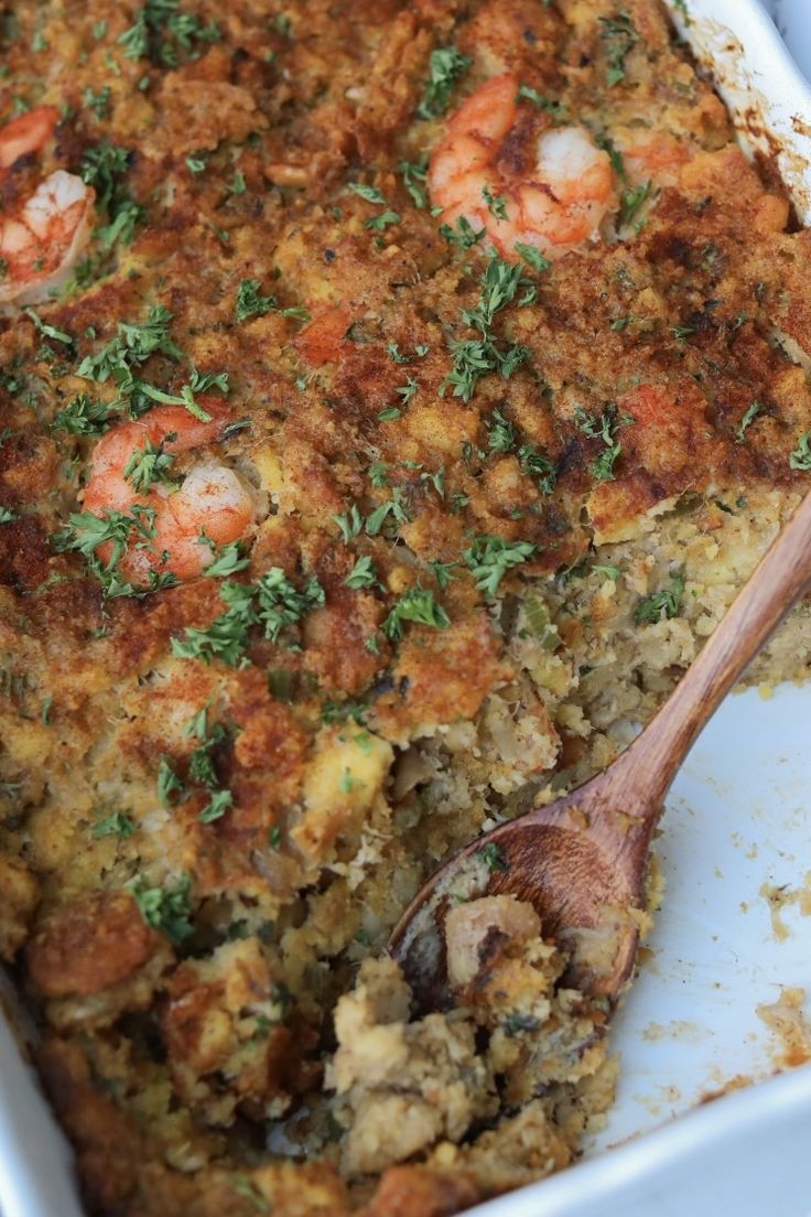 a casserole dish with shrimp and parsley on top, ready to be eaten