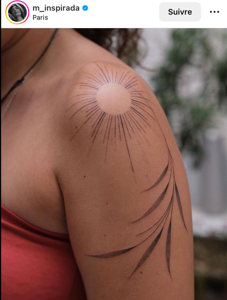 a woman with a sun tattoo on her arm