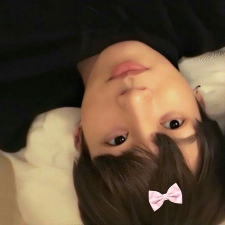 a man with a pink bow tie laying down